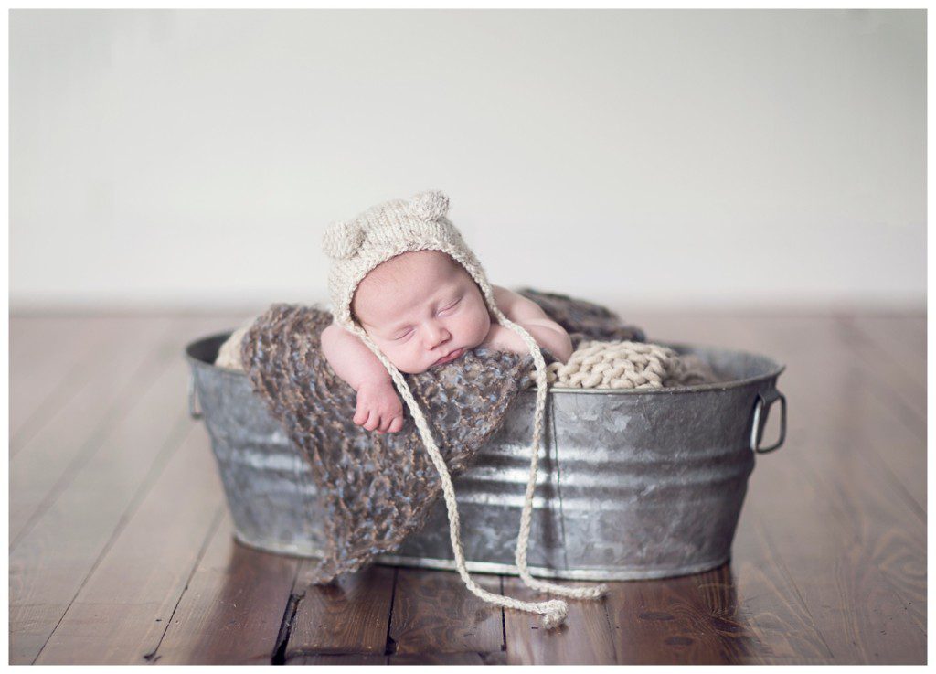 newborn in bucket with cute hat