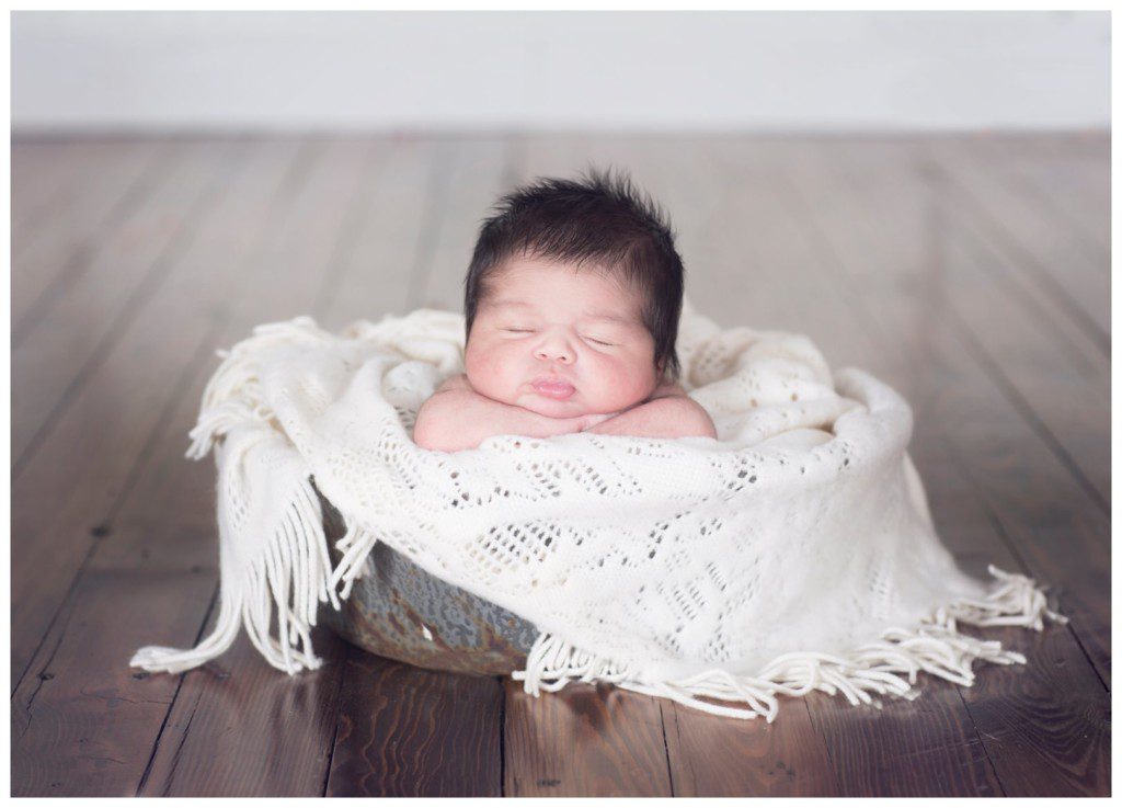 newborn with hair in basket