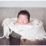 newborn with hair in basket